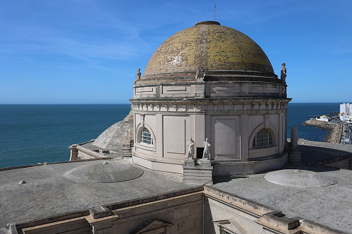 A view of the dome of the Cathedral of Cadiz, as seen dome the bell tower and looking towards the ocean.  There are several architectural jewels in Cadiz, the oldest establishment in Europe.