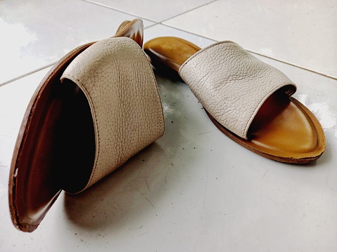A pair of women's sandals on the floor.