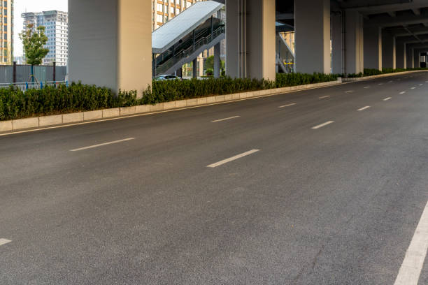 istock empty asphalt road under modern fly over in downtown of city. 1485759423