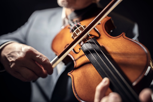 Violinist player musician in orchestra hands playing classical music on violin