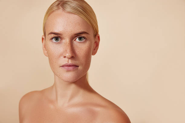 istock Young blond woman with naturally smooth skin against a pastel backdrop 1485759775
