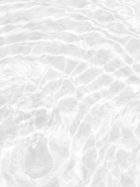 istock White water with ripples on the surface. Defocus blurred transparent white colored clear calm water surface texture with splashes and bubbles. Water waves with shining pattern texture background. 1485759944