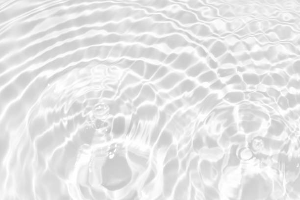 istock White water with ripples on the surface. Defocus blurred transparent white colored clear calm water surface texture with splashes and bubbles. Water waves with shining pattern texture background. 1485761358