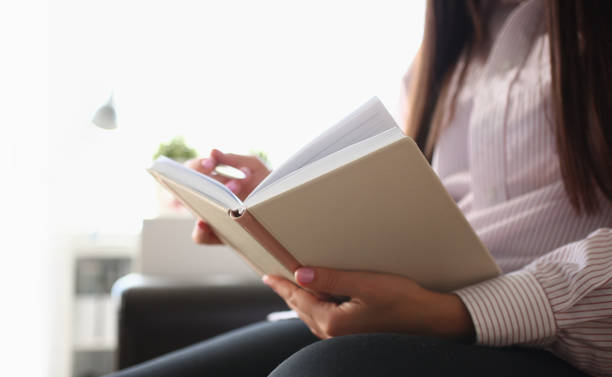 istock Closeup of female author writing notes in journal at home 1485761664