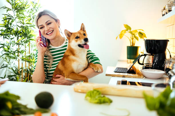 istock Woman is talking on the phone in the kitchen 1485762048