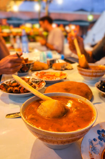 Local food in street restaurants in Marrakech's  Djemma El Fna square Local food in street restaurants in Marrakech's  Djemma El Fna square. When it comes to soup in Moroccan cuisine, the first dish that comes to mind is harira soup. djemma el fna square stock pictures, royalty-free photos & images