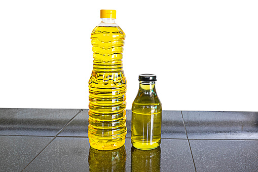 A bottle of vegetable or cooking oil on the table, white background.clipping path.