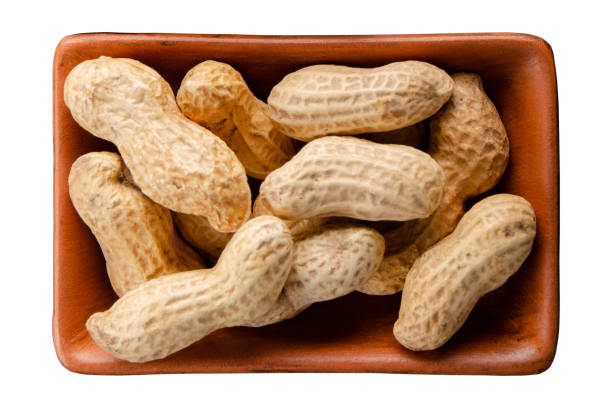 istock Peanuts in clay bowl isolated on white flat lay view 1485764324