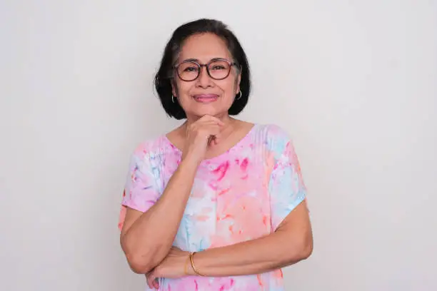 Asian elderly women smiling confident with hand touching chin