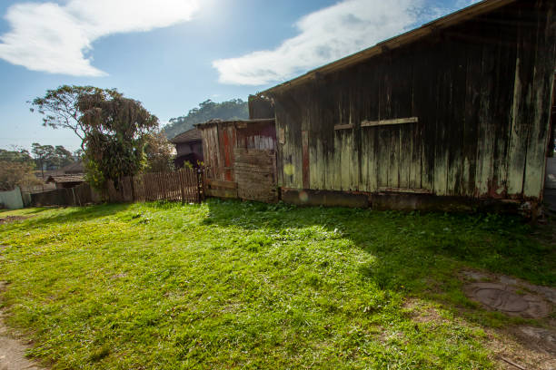Paranapiacaba, Santo Andre, Brazil – July, 10, 2016: back facade of an old abandoned wooden home at the inner city.