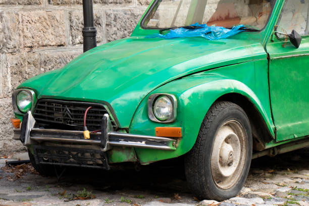Plateless neglected green old timer parked in the old street Belgrade, Serbia -February 23, 2023: Plateless weathered and damaged green old timer parked in the old cobble stone street. distressed rusty vintage pickup truck close up detail stock pictures, royalty-free photos & images