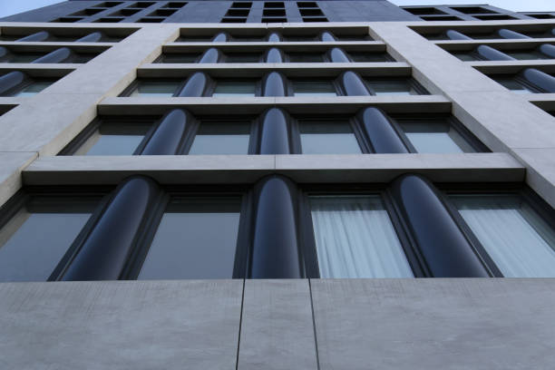 istock tall buildings detail looking up (urban architecture, commercial, residential, apartment) brutalist style, cold, dark, symmetrical 1485765921