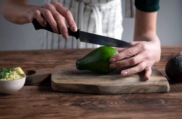 istock Woman hands Cutting Avocado 1485767277