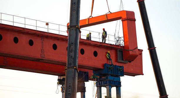 Engineer and worker are working build sky hiway on crane construction. stock photo