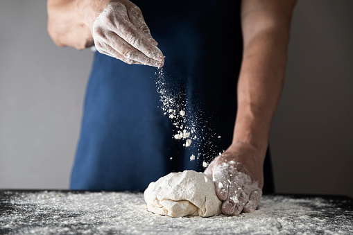 Kneading dough with ingredients in domestic kitchen