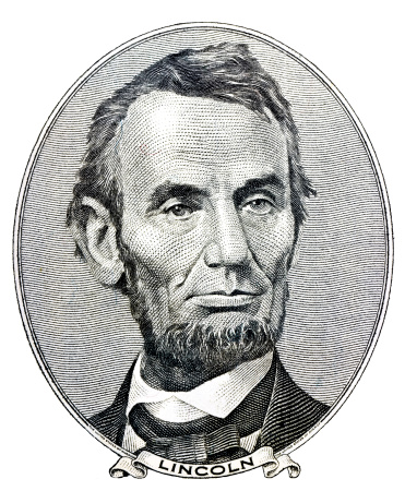 Portrait of former U.S. president Abraham Lincoln as he looks on five dollar bill obverse