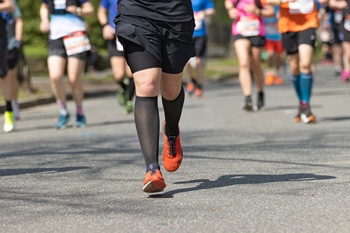 marathon runner with black socks and red shoes