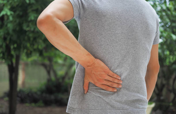 istock man holding her lower back while and suffer from unbearable pain health and problems, chronic back pain, backache in office syndrome, scoliosis, herniated disc, muscle inflammation 1485776775