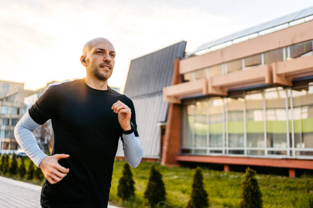 istock Young Man Jogging Outdoors In A Park 1485776938