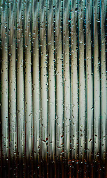 istock Window glass surface with a strip pattern in the rain. Shot in close up with selective focus. Great for background and pattern designs. 1485777256