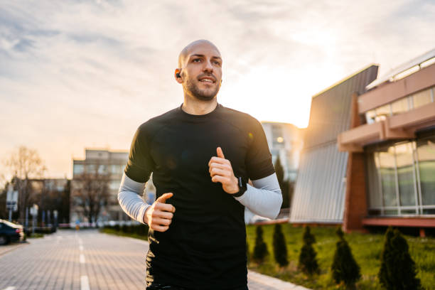 istock Young Man Jogging Outdoors In A Park 1485777481