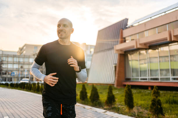 istock Young Man Jogging Outdoors In A Park 1485778431