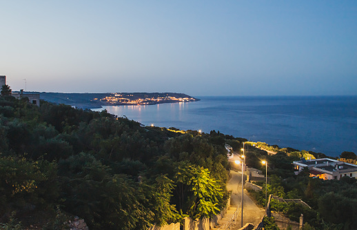 In the distance the city of Santa Cesarea Terme and the calm waters of the Ionian Sea at sunset.
