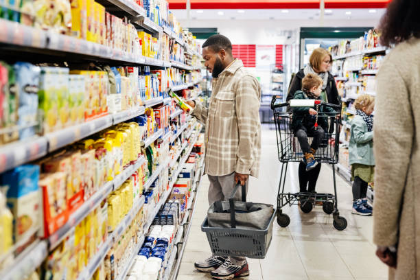 istock Man Reading Product Packaging While Shopping For Groceries 1485785510