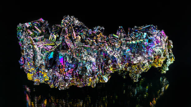 Beautiful colored silicon carbide mineral crystals with reflection on a black background