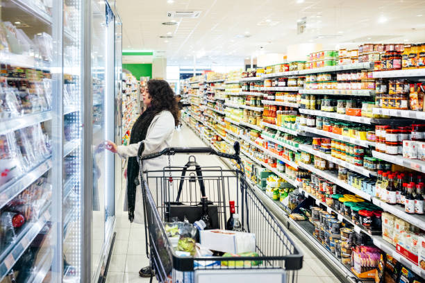 istock Woman Browsing Refrigerator While Shopping For Groceries 1485786247