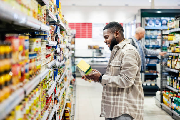 istock Man Reading Ingredients On Product Packaging While Shopping For Groceries 1485787444