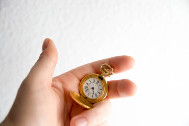 istock Hand with a golden  pocket watch. Concept time. Space copy 1485790266