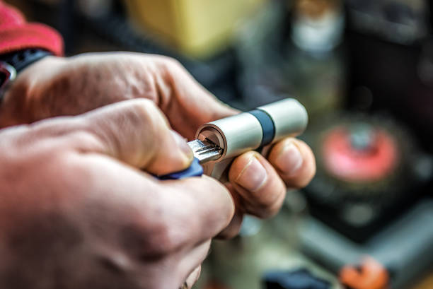 Testing door lock cylinder with key. Locksmith theme stock photo