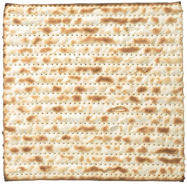 Close-up shot of a matzo isolated on a white background stock photo