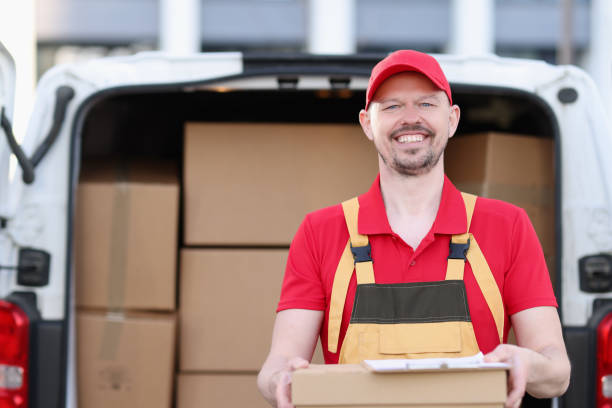 istock Smiling male courier pulling box in background of car 1485794220