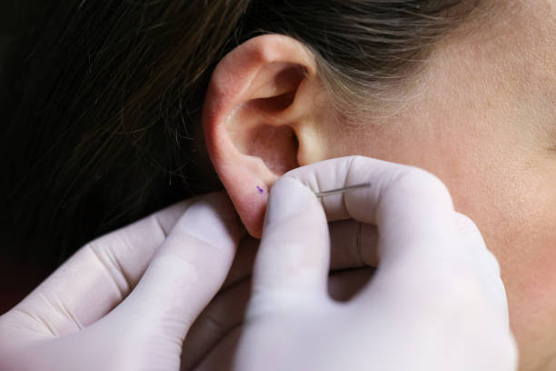 istock Young woman puncturing her ear 1485794392