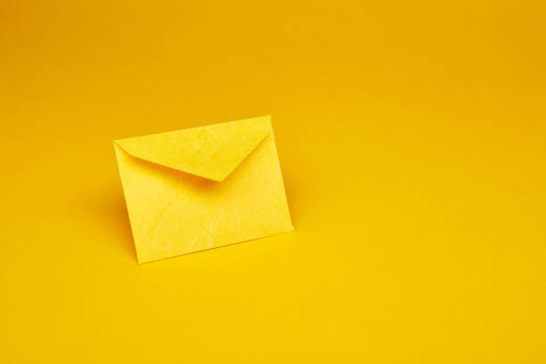 istock Yellow office envelope for greeting or invitation on the yellow background 1485796458