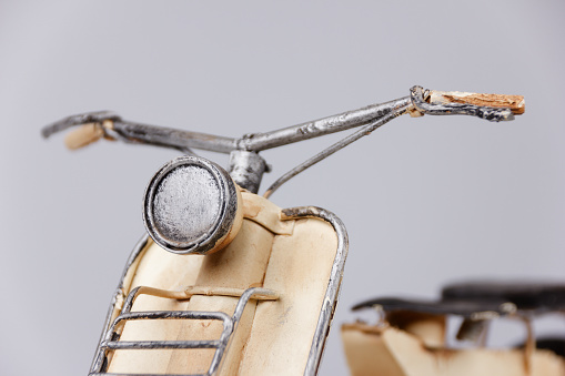 detailed view of motor scooter model on white table with white background