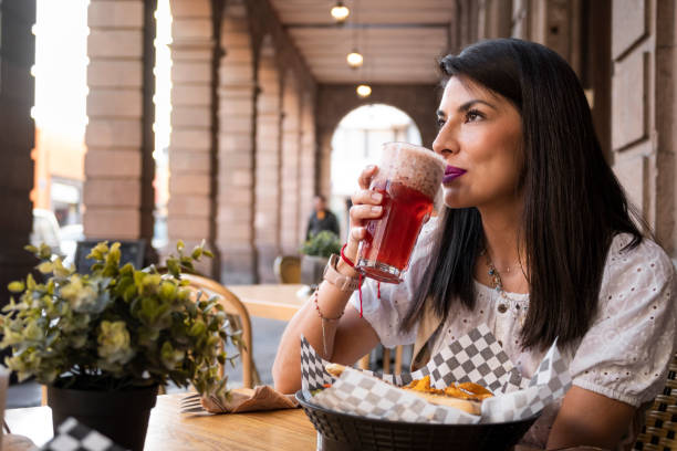 istock mexican woman drinking a refreshing craft drink in a typical restaurant in mexico 1485799767
