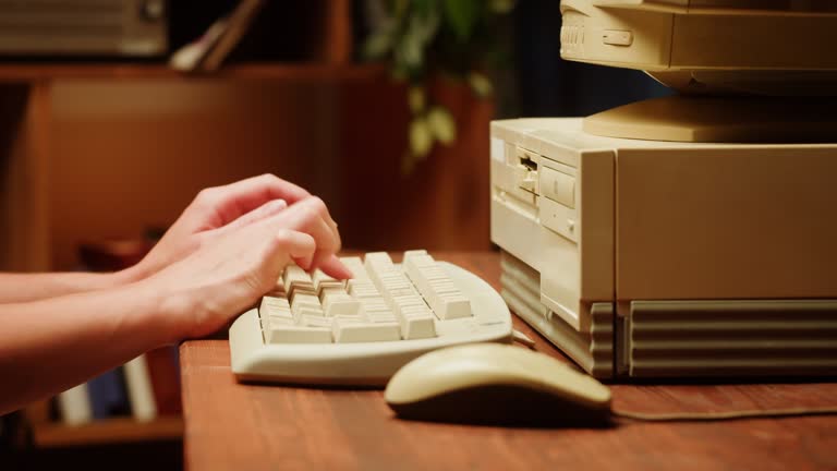 Using CD circle disk for old computer and typing on keyboard. Dvd player, disc drive. Music recorder, playing retro computer games.