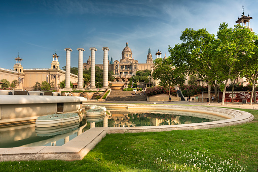 Barcelona, Spain - June 17, 2022: Palau Nacional or Montjuïc National Palace Art Museum of Catalonia and the Magic Fountain in Barcelona Spain which was the main site of the 1929 International Exhibition