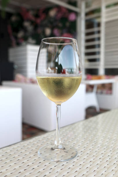 istock Glass of white wine on table 1485805525