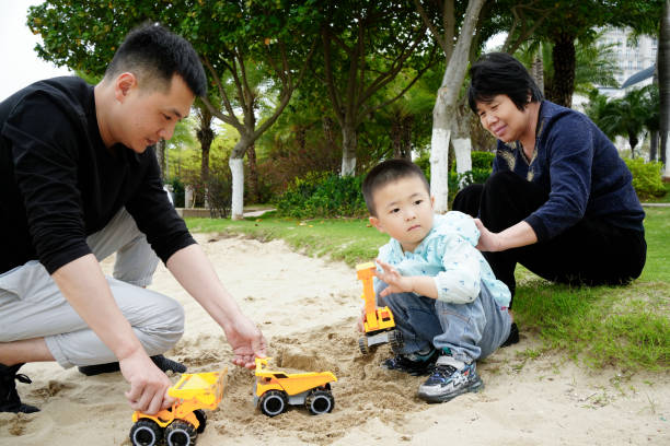 Grandma watched father and son playing on the beach