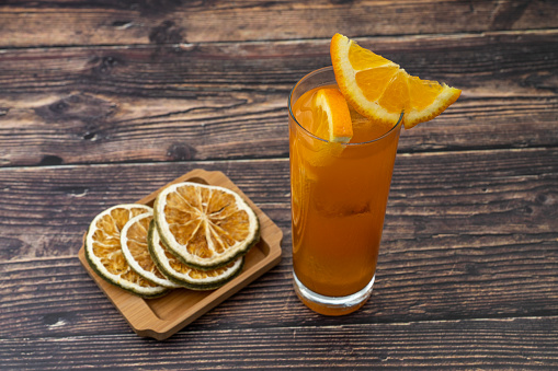 Orange juice with dry orange slices.