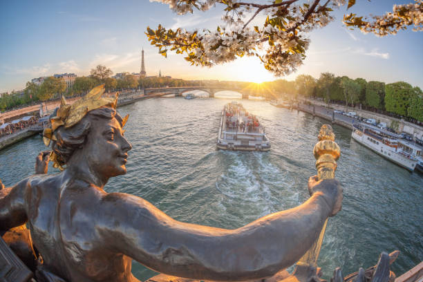 Alexandre III bridge in Paris against Eiffel Tower with boat on Seine, France Alexandre III bridge in Paris against Eiffel Tower with boat on Seine, France champ de mars stock pictures, royalty-free photos & images