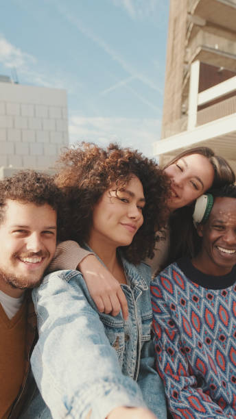 istock Happy smiling friends make a video call from a mobile phone. Four students wave their hands in greeting 1485808871