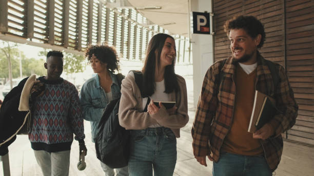 istock Laughing student couple talking walking together 1485808892