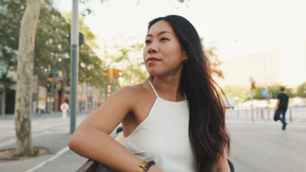 istock Young woman is sitting on bench, looking away 1485809093
