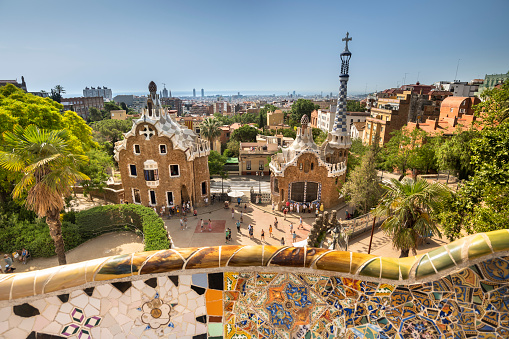 Barcelona, Spain - June 14, 2022:  City skyline summer views from Park Guell designed by artist and architect Antoni Gaudi in Barcelona Catalonia Spain