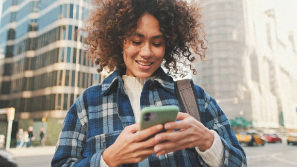 istock Young smiling woman using mobile phone 1485809907